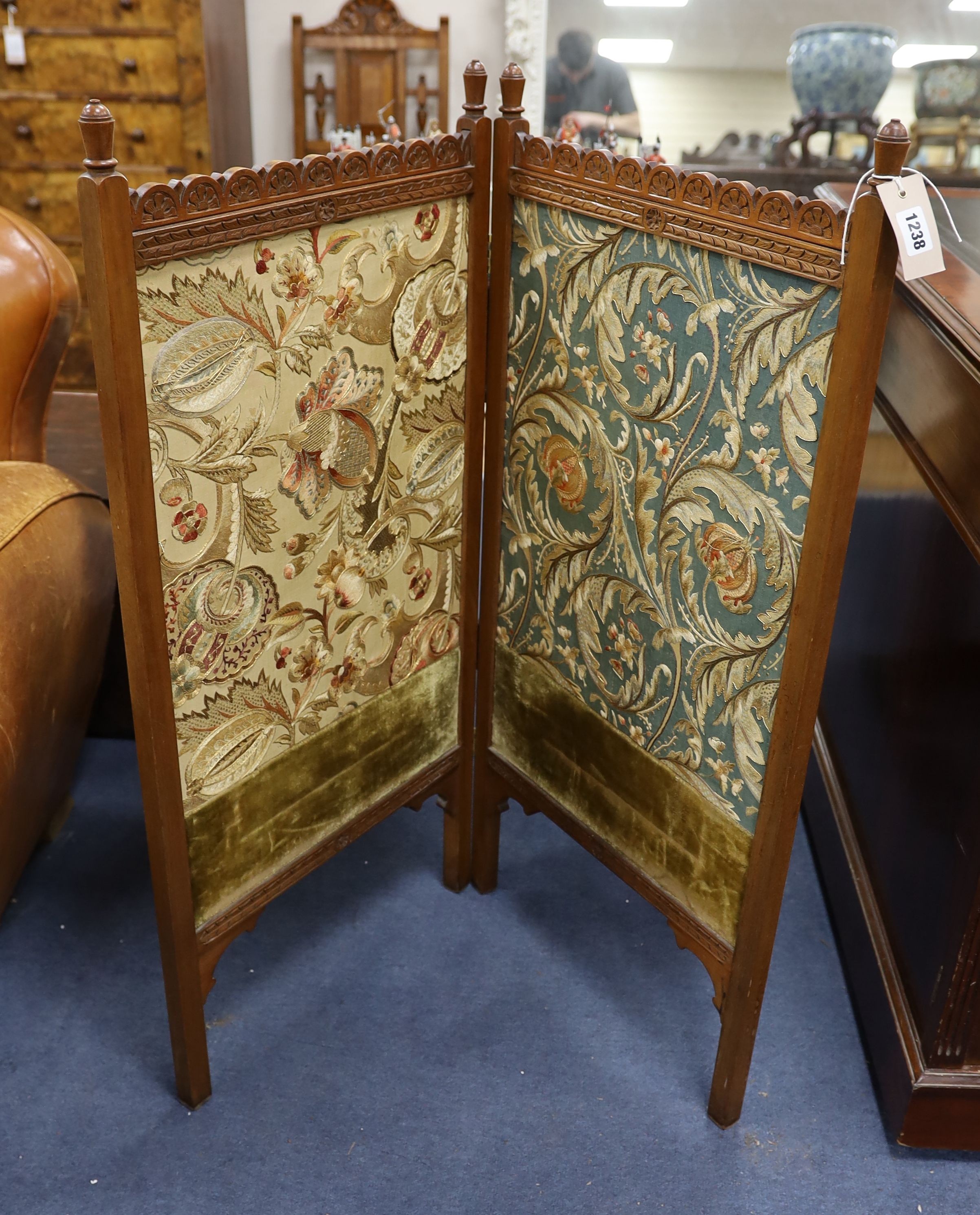 An Arts and Crafts Morris-style embroidered two-fold mahogany framed screen, each panel width 47cm, height 97cm, the embroidery design in the manner of May Morris